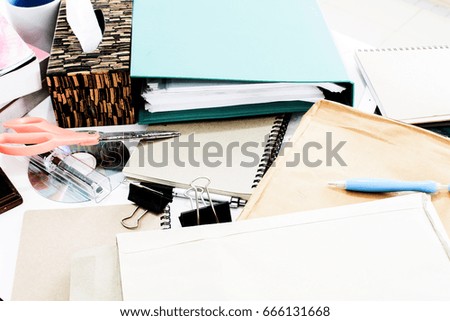 Top view of office desk with paper, stationery and tablet computer. Concept of Many documents on office desk. stack of folders and documents.