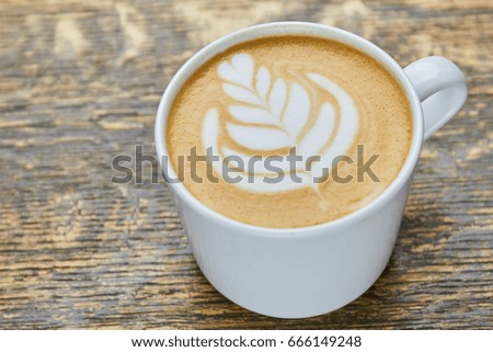 Latte with flower picture. Close up of coffee. Sip of the art.