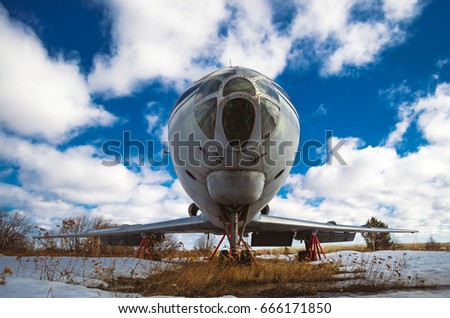 Old Soviet aircraft on the conservation against the background of clouds