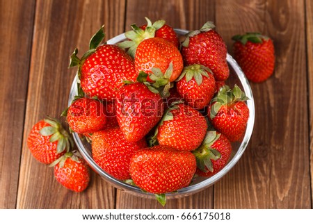 Picture of fresh ripe strawberry in cup on wooden table