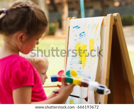 Pre-school children painting at the park
