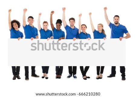Happy Multiracial Janitors With Banner Raising Their Arms