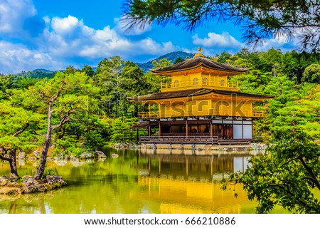 Beautiful architecture at Kinkaku-ji (Temple of the Golden Pavilion), officially named Rokuon-ji (Deer Garden Temple), a Zen Buddhist temple in Kyoto, Japan. Kinkakuji Temple under blue cloudy sky day Royalty-Free Stock Photo #666210886