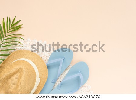 Summer fashion, summer outfit on cream background. White lace dress, blue flip flops and straw hat. Flat lay, top view.