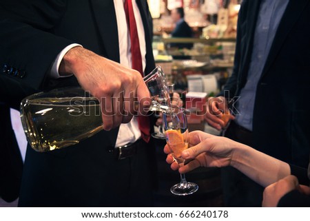 man pours wine, elegant person offers wine to the woman