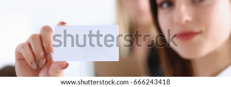 Smiling Business woman in suit hold in hand blank calling card closeup. White collar partners company name exchange, executive or ceo introducing at conference, product consultant, sales clerk concept