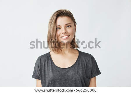 Portrait of young beautiful cute cheerful girl smiling looking at camera over white background. Royalty-Free Stock Photo #666258808