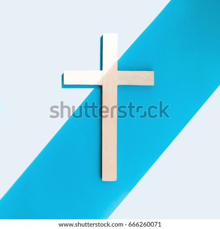 Cross on a blue and white background. Minimalism
