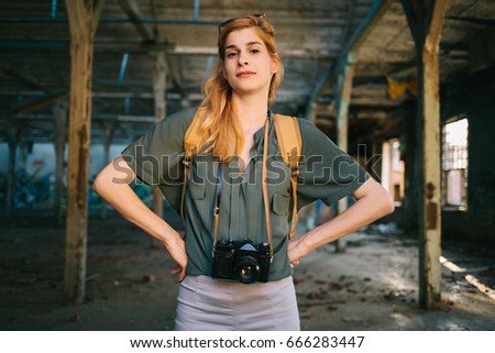 Girl photographer posing with vintage camera
