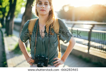 Tourist photographer with retro camera. Travel girl with backpack and retro photo camera
