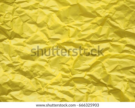 Abstract yellow crumpled paper texture background for design artwork or decorative.