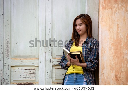 Reading book with a beautiful Asian girl in the ancient place.
