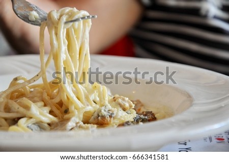 Spaghetti Carbonara - spaghetti on fork Royalty-Free Stock Photo #666341581