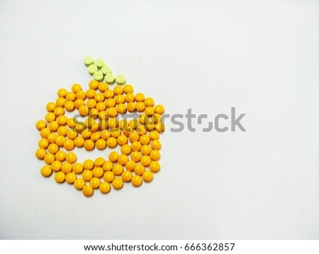 Pharmaceutical medicine pills,pill tablets and capsules pumpkin on white background concept Halloween day