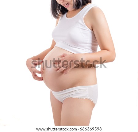 Asian girl pregnant, She scratching her belly. Royalty-Free Stock Photo #666369598