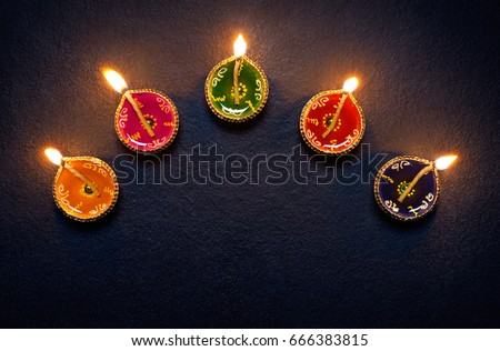 Colorful clay diya lamps lit during diwali celebration Royalty-Free Stock Photo #666383815