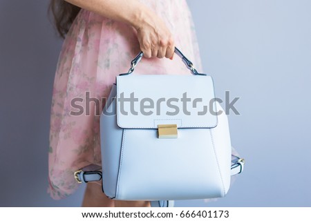 Close up stylish woman in pink skirt with blue bag. Fashion concept. Royalty-Free Stock Photo #666401173