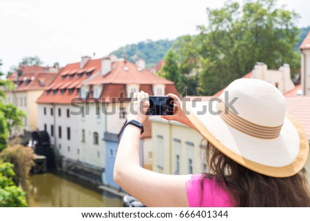 Female tourist taking a photo with mobile phone