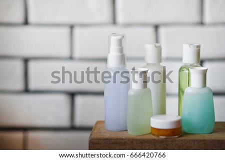 Bathroom accessories. Body care. Multi-colored natural soap, gels, shampoos, balms in vials, sea salt for a bath, a bast. Bathroom cosmetics on a light, white background. Spa treatments with candles