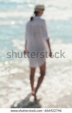 Art blur photo of a woman walking on the sea. Harmony, meditation and travel concept.