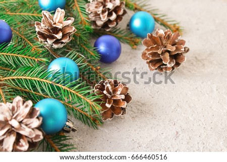 Christmas, background with Christmas fir-tree, cones and toys