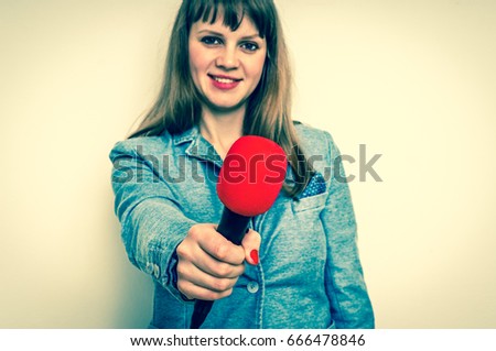 Female reporter with red microphone making interview - journalism and broadcasting concept - retro style