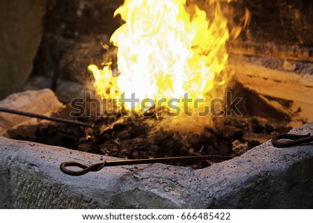 Carbon fire in a forge, detail of a workshop with iron
