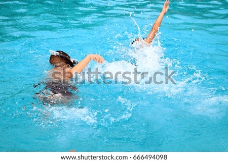 Two boys Is competing swimming in the pool At the sports club.