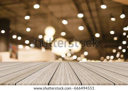 abstract blurred lamp light on ceiling with wood floor panel for show,advertise product on this display