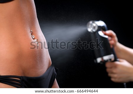 Woman body paint with airbrush in professional beauty salon Royalty-Free Stock Photo #666494644