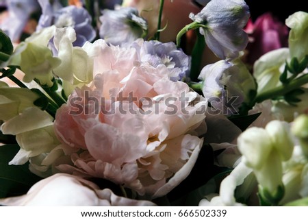 Luxury bouquet of peonies, roses and eustoma flowers on black background. Close up