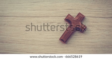 Wooden cross on wooden background church with blank copy space