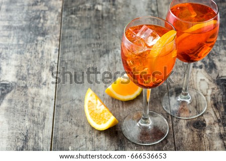Aperol spritz cocktail in glass on wooden table
 Royalty-Free Stock Photo #666536653