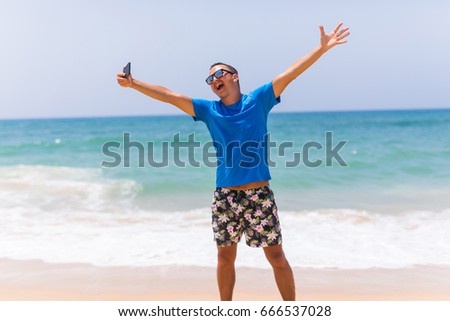 Cheerful man selfie with palm trees background in tropical island self male tourist portrait