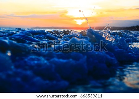 Waves on the beach in the tropics at sunset