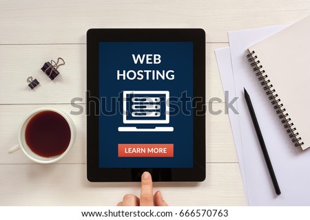 Web hosting concept on tablet screen with office objects on white wooden table. Flat lay