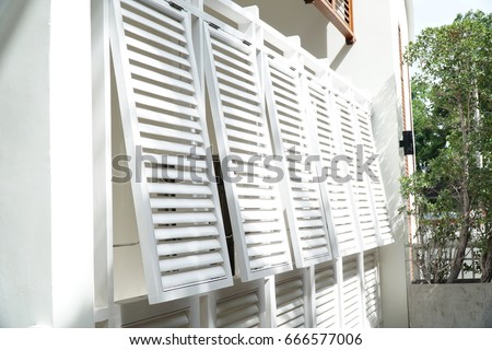 White louver window on the wall of the hotel. Royalty-Free Stock Photo #666577006
