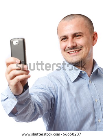 Young businessman taking photos with his cellphone