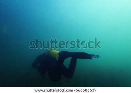 Diver swims under water  flippers Scuba