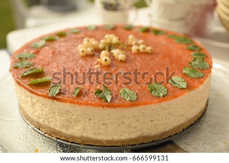 Close up of a Midsummer cake , a sea buck thorn cheesecake with White currant berry in the middle, picture from the Northern Sweden.