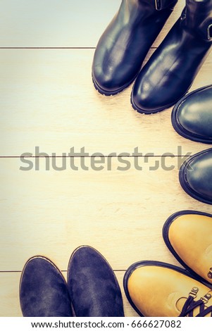 Leather boots and shoes on wooden background - Vintage Filter
