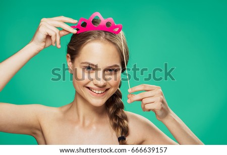 Woman with paper accessory on a green background                               