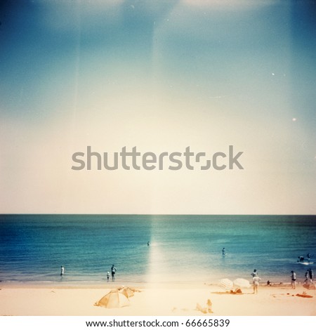 Retro medium format photo. Sunny day on the beach. Grain, blur added as vintage effect.