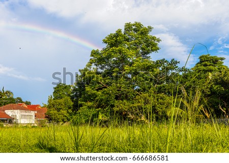 
The middle house meadows with a rainbow with the cloud in Thailand