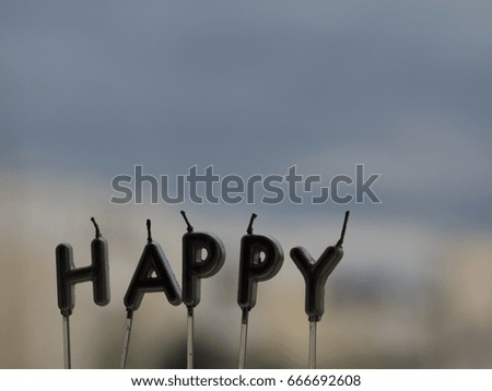Letter HAPPY from candles on window sill background. Happy concept