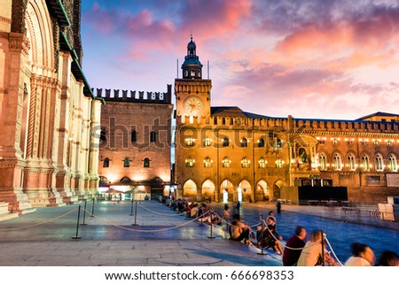 Colorful spring sunset on the main square of City of Bologna with Palazzo d'Accursio and facade of Basilica di San Petronio. Great cityscape of Bologna, Italy, Europe. Traveling concept background.

