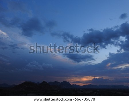 Twilight, Evening Blue and Dark sky, Orange light, Dusk, Black and White clouds, twilight over the Mountains