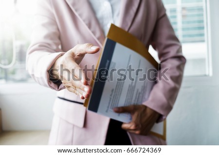 Business find new job, interview the job and hiring. Job applicant holding resume.Open handshake and resume job interview or acceptance.  Royalty-Free Stock Photo #666724369