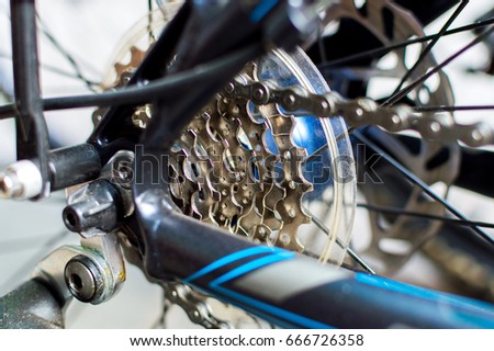 Detail of rear bicycle wheel with chain and gear system