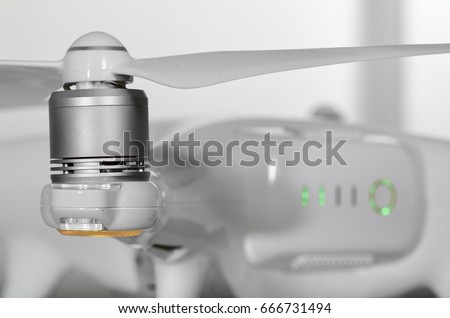 A drone battery and a propeller, focus is on the propeller